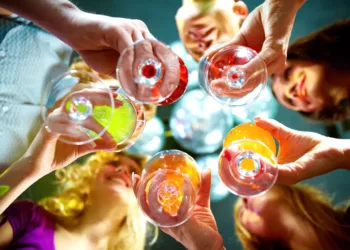 Below view of people clinking glasses with each other