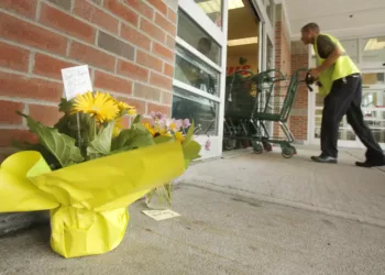 SACO, ME - AUGUST 20: People have placed flowers outside of the entrance to Shaw's supermarket in Saco on Thursday morning. Wendy Boudreau, 59, died after being stabbed  inside the supermarket on Wednesday and police have charged Connor MacCalister, 31, with her murder. (Photo by Gregory Rec/Staff Photographer)