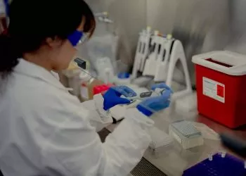 A scientist works at the Pfizer vaccine research and development facility in Pearl River, New York, US, on Thursday, June 16, 2022. Pfizer Inc. emerged from the Covid-19 pandemic as the worlds most visible drugmaker, but its success has left investors impatient for an encore. Photographer: Amir Hamja/Bloomberg