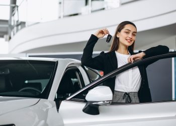 Woman choosing a car in a car showroom