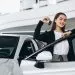 Woman choosing a car in a car showroom