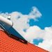 Solar water heater on rooftop, beautiful summer blue sky in the background.
