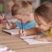 Little girl drawing in her notebook