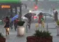 Bucharest, Romania. 9th Jun, 2025: People cross a heavily flooded street after a strong storm rain in Bucharest.