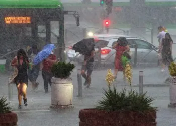 Bucharest, Romania. 9th Jun, 2025: People cross a heavily flooded street after a strong storm rain in Bucharest.